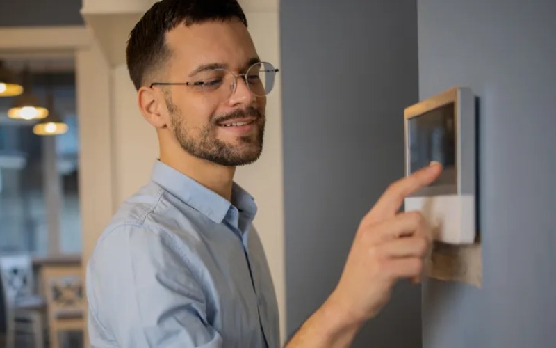 man-using-smart-thermostat